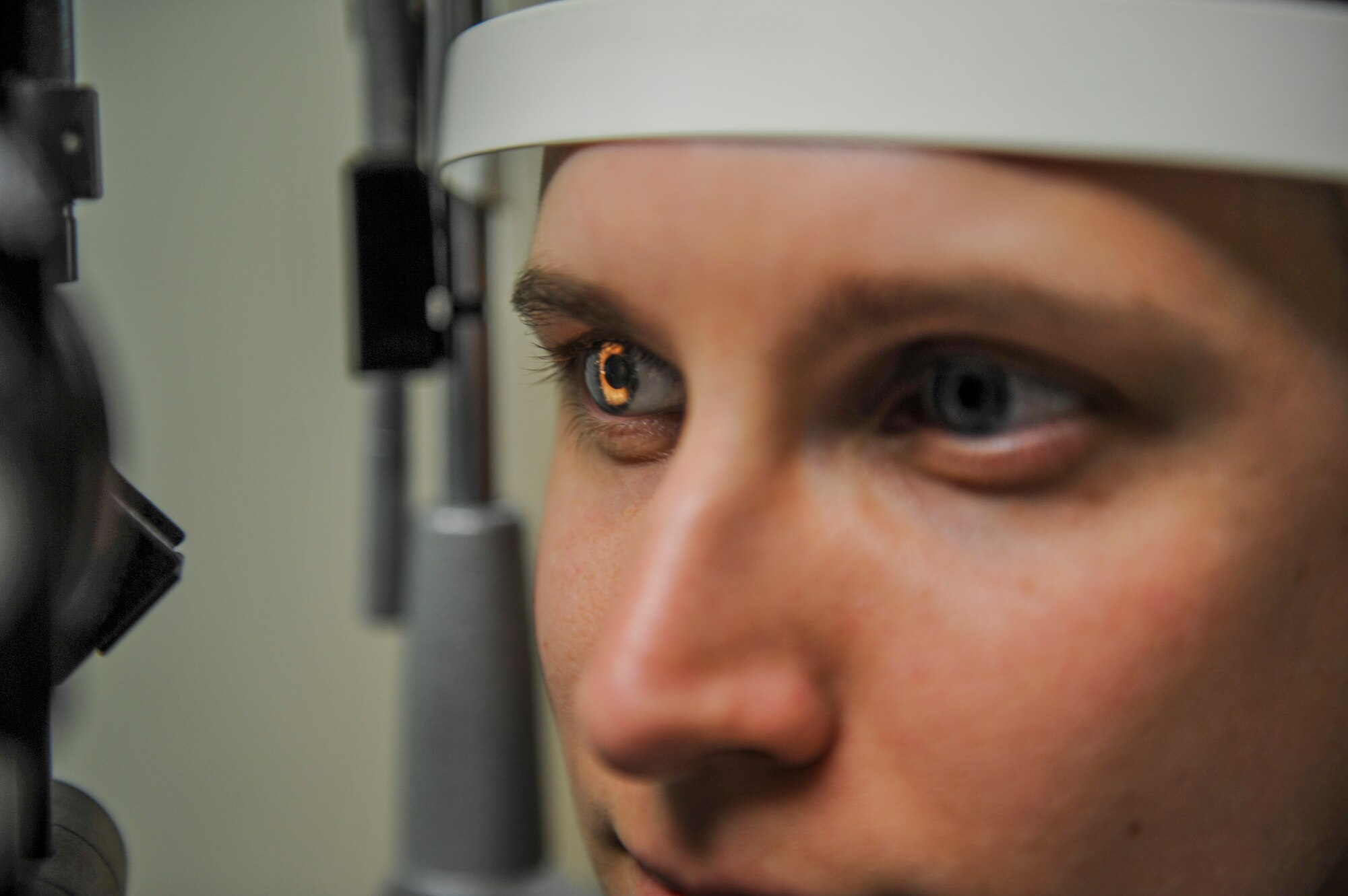 U.S. Air Force Staff Sgt. River Carson, 8th Medical Operations Squadron public health technician, stares through the slit lamp during his eye exam at Kunsan Air Base, Republic of Korea, March 24, 2017. The slit lamp uses an intense beam of light to show the eye in detail to check for abnormalities during eye checkups. (U.S. Air Force photo by Senior Airman Colville McFee/Released)