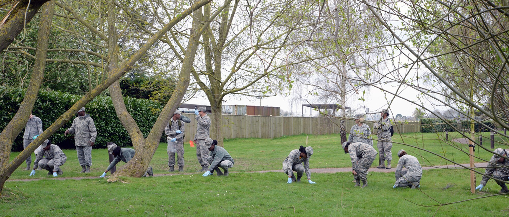 U.S. Air Force and Air Force Reserve Airmen form a line and make details of the surrounding area during the aircraft crash response/search and recovery training April 7, 2017, on RAF Lakenheath, England. Airmen from RAF Mildenhall, RAF Lakenheath and the 927th Force Support Squadron, MacDill Air Force Base, Fla., participated in the training to educate and expose them to one of the critical and difficult tasks they may be asked to support in their careers. (U.S. Air Force photo by Karen Abeyasekere)