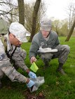 A U.S. Air Force Reserve staff sergeant, left, from the 927th Force Support Squadron,MacDill Air Force Base, Fla., and U.S. Air Force Airman from the 48th Force Support Squadron, mark identifying tags on items simulating aircraft parts and human remains during an aircraft crash response/search and recovery training April 7, 2017, on RAF Lakenheath, England. Airmen from RAF Mildenhall, RAF Lakenheath and the 927th Force Support Squadron, MacDill Air Force Base, Fla., participated in the training to educate and expose them to one of the critical and difficult tasks they may be asked to support in their career. (U.S. Air Force photo by Karen Abeyasekere/names blurred for security purposes)