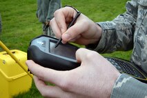 A U.S. Air Force Airman from the 100th Civil Engineer Squadron Engineering Execution Support office inputs detailed coordinate information via Bluetooth into a TS-C3 survey controller during an aircraft crash response/search and recovery training April 7, 2017, on RAF Lakenheath, England. Airmen from RAF Mildenhall, RAF Lakenheath and 927th Force Support Squadron Reserves, MacDill Air Force Base, Fla., worked together during the training scenario. (U.S. Air Force photo by Karen Abeyasekere)