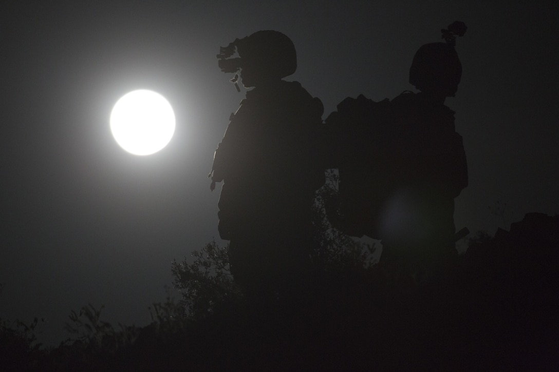 U.S. Marine Corps Capt. David Hirt, left, AH-1 instructor and Maj. Stephen Piantarnida, AH-1 instructor with Marine Aviation Weapons and Tactics Squadron One observe the terrain using night vision goggles during offensive air support exercise 5 in support of Weapons and Tactics Instructor course 2-17 at Chocolate Mountain Aerial Gunnery Range, Arizona, April 11, 2017. OAS is designed to focus on the integration of all air combat element aviation assets with a developed ground scheme of maneuver to conduct close air support. WTI is a seven-week training event hosted by MAWTS-1 cadre, which emphasizes operational integration of the six functions of Marine Corps aviation in support of a Marine Air Ground Task Force and provides standardized advanced tactical training and certification of unit instructor qualifications to support Marine Aviation Training and Readiness and assists in developing and employing aviation weapons and tactics.