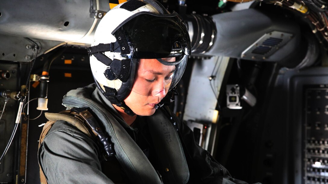 Sgt. 1st Class Midsru Miyazaki puts on his gear before a flight at Marine Corps Air Station New River, N.C., April 7, 2017. Miyazaki is currently training with VMMT-204 where he works closely with Marines in order to learn the skills necessary to become a crew chief. His gear consists of his helmet with built in communication system and eye protection, a flack and a life preserver. VMMT-204 is assigned to Marine Aircraft Group 26, 2nd Marine Aircraft Wing. 