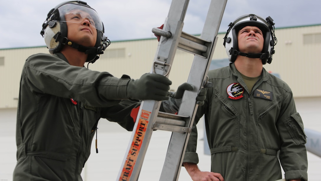 Sgt. 1st Class Midsru Miyazaki, left, and 1st Lt. Hunter Trotman, right, observe a Marine maintaining a MV-22 Osprey engine at Marine Corps Air Station New River, N.C., April 7, 2017. Miyazaki is training to become the first Japanese crew chief of a MV-22 Osprey. Before every flight the crew chief has to check all mechanical systems both inside and outside the aircraft to ensure proper safety of crew. Trotman is a MV-22 Osprey pilot in training assigned to VMMT-204. VMMT-204 is assigned to Marine Aircraft Group 26, 2nd Marine Aircraft Wing. 