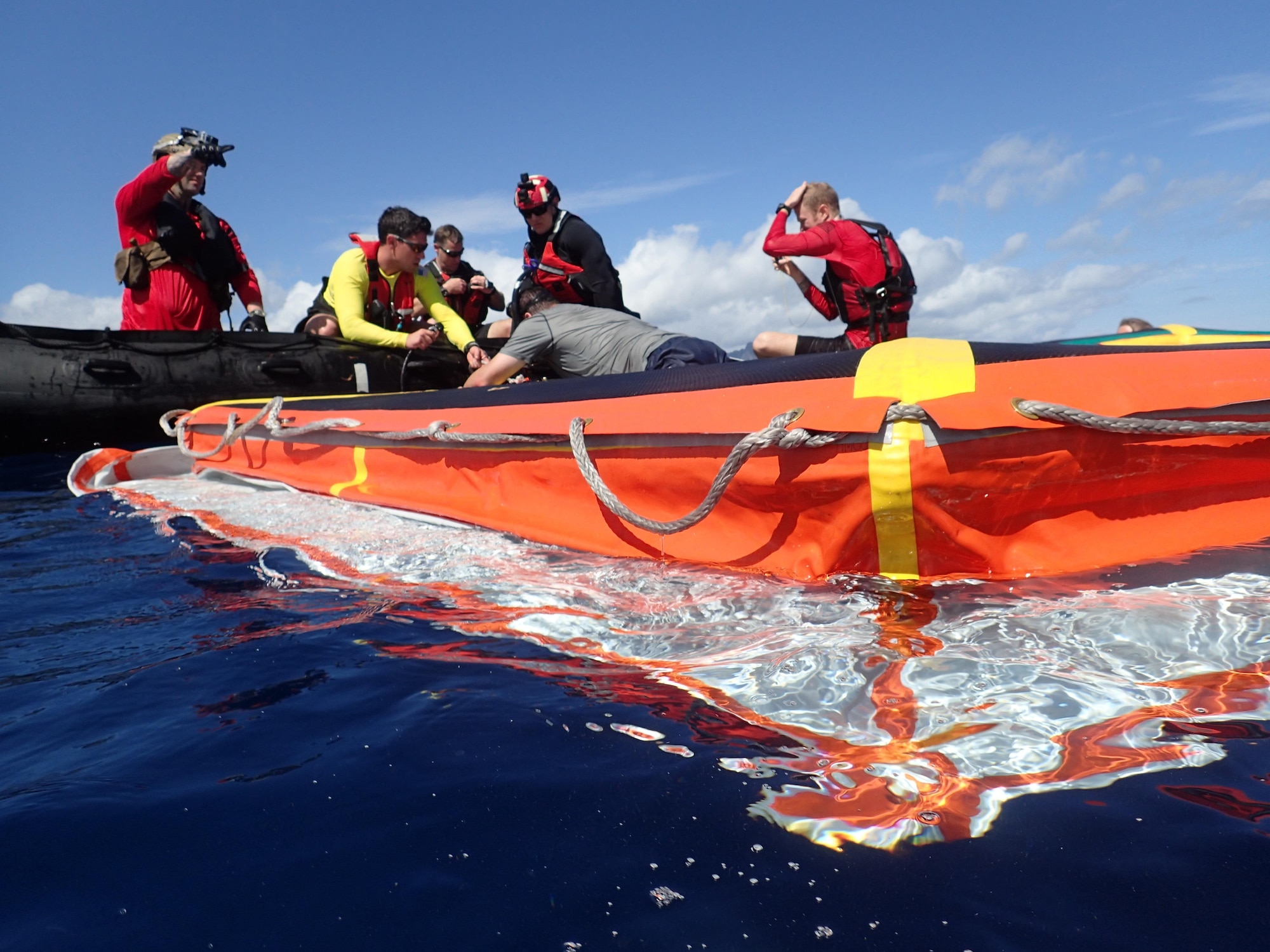 Pararescuemen of the 103rd Rescue Squadron of the 106th Rescue Wing of the New York Air National Guard erect the "front porch" support equipment for NASA's new Orion spacecraft crew module in the waters off Marine Base Hawaii in Hawaii on March 7, 2017. The New York Air National Guard pararescuemen, as well as active Air Force pararescuemen were testing equipment which would be used to support Orion astronauts in the event of a contingency recovery operation. (U.S. Air National Guard photo by Capt. Michael O'Hagan)
