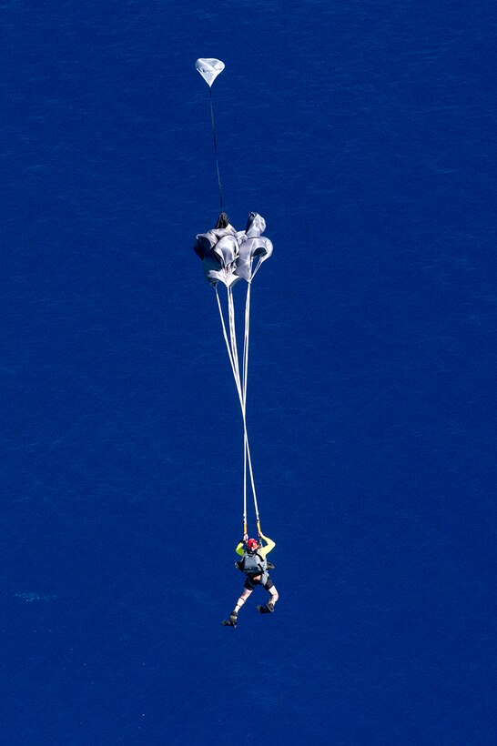 Pararescuemen and Combat Rescue Officers with the New York Air National Guard's 103rd Rescue Squadron, 106th Rescue Wing, supported by the Hawaii Air National Guard's 154th Wing, 204th Airlift Squadron, jump from a C-17 into the waters off Joint Base Pearl Harbor- Hickam on March 7, 2017 as they conduct training to test new spacecraft recovery techniques and equipment that will be used to recover the crew module of NASA's Orion spacecraft. The Airmen were in Hawai for two weeks as part of Operation Ardent Sentry. ( U.S. Air National Guard photo by Staff Sgt. Christopher Muncy)