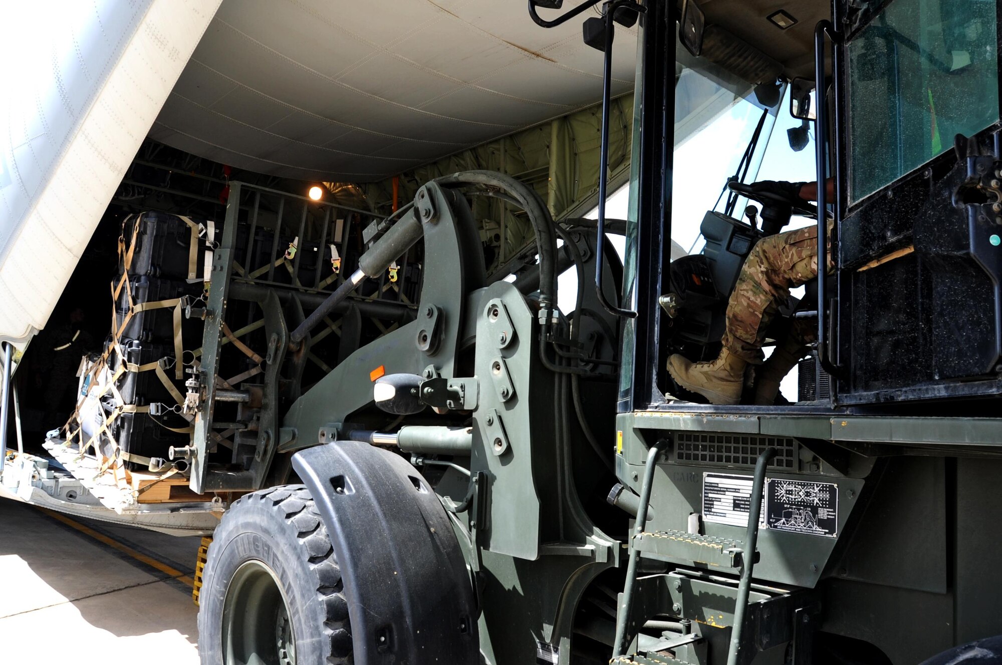 Airman 1st Class Carlos Tubbs, a 442nd Air Expeditionary Squadron aircraft services  specialist, unloads a pallet of cargo off of a Marine C-130 at the Baghdad Diplomatic Support Center, Iraq March 21, 2017. Tubbs is responsible for loading and unloading aircraft in support of Combined Joint Task Force - Operation Inherent Resolve missions. (U.S. Air Force photo/Tech. Sgt. Kenneth McCann)