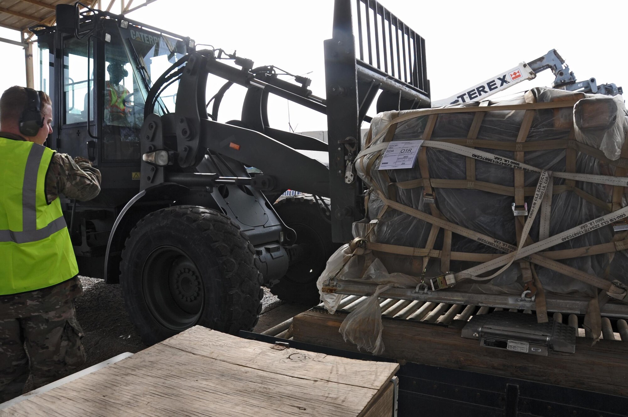 Senior Airman Matthew Anderson and Airman 1st Class Carlos Tubbs, 442nd Air Expeditionary Squadron aircraft services specialists, weigh a pallet of cargo March 21, 2017, at the Baghdad Diplomatic Support Center, Iraq. Aerial Porters are responsible for transporting cargo in and out of the BDSC in support of Combined Joint task Force - Operation Inherent Resolve. (U.S. Air Force photo/Tech. Sgt. Kenneth McCann)