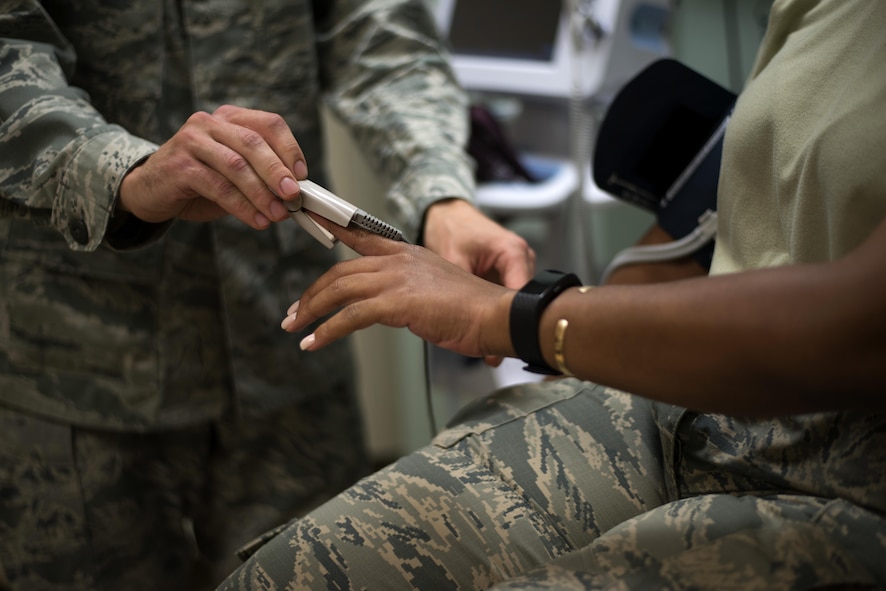 U.S. Air Force Staff Sgt. Aliaksei Krasouski, a medical technician assigned to the 91st Air Refueling Squadron, attaches a machine to monitor the heart rate of a patient March 8, 2017, at MacDill Air Force Base, Fla. Krasouski joined the Air Force after emigrating from Minsk, Belarus. (U.S. Air Force Photo by Airman 1st Class Rito Smith)