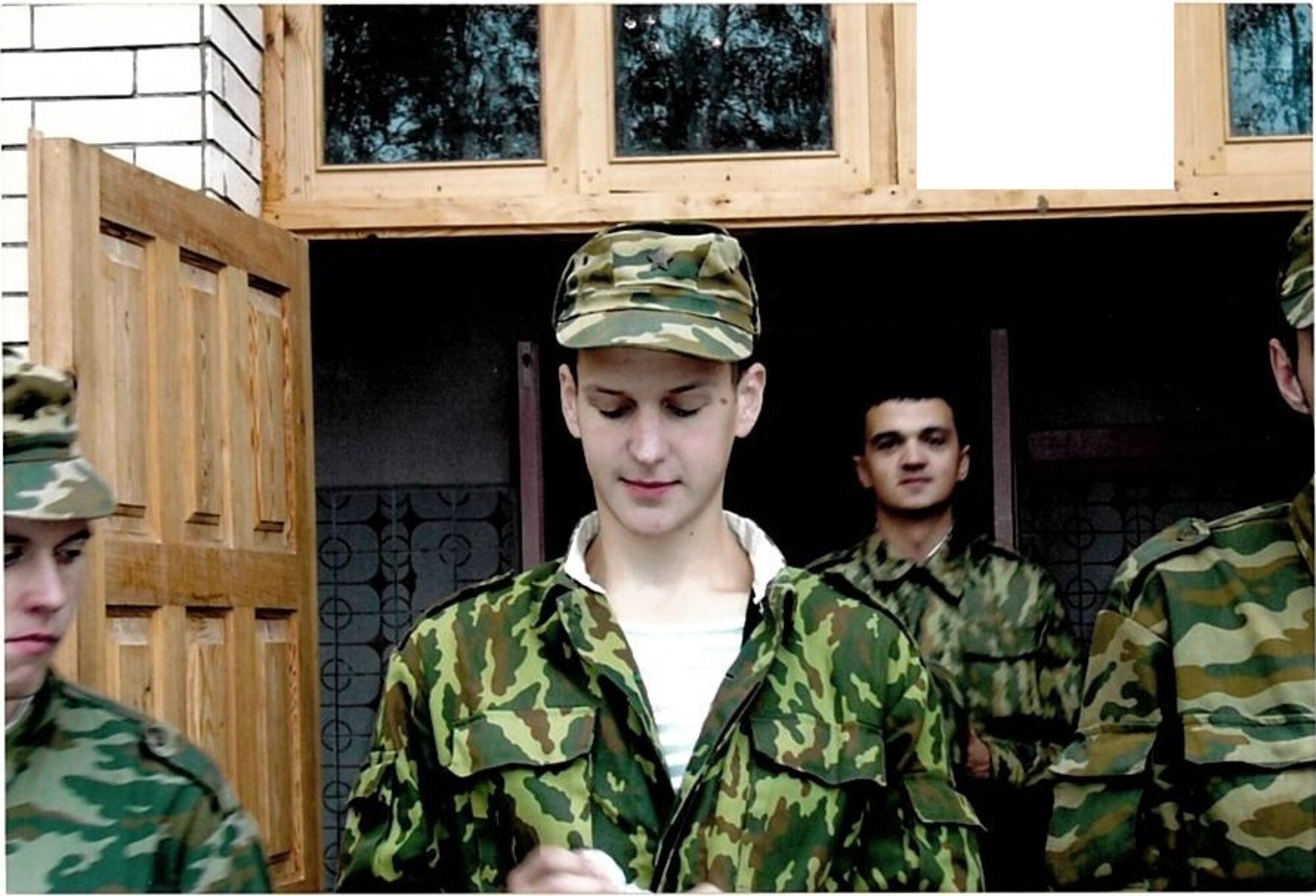 Aliaksei Krasouski, center, stands with fellow Belarussian airmen in August 2004 during his time in the Belarussian Air Force. Before coming to the U.S. and becoming a medical technician in the U.S. Air Force, Krasouski lived in Minsk, Belarus and served in the Belarussian Air Force. (Courtesy Photo) 