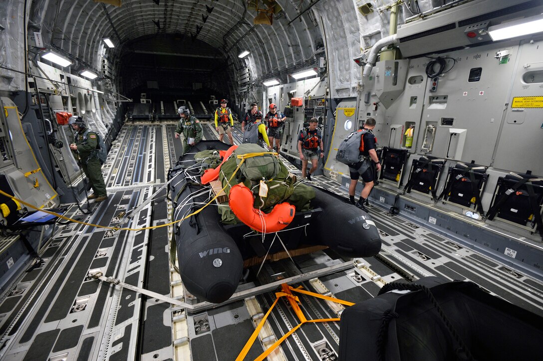 NewYork Air National Guard pararescuemen and Combat Rescue Officers assigned to the 103rd Rescue Squadron of the 106th Rescue Wing prepare to drop a preloaded inflatible boat from a C-17 flown by the Hawaii Air National Guard's 204th Airlift Squadron of the 154th Wing into the waters off Joint Base Pearl Harbor- Hickam on March 6, 2017. This training was conducted alongside NASA personnel at Joint Base Pearl Harbor-Hickam, Hawaii during Exercise SENTRY ALOHA March 6, 2017. A major element of this two week TDY is to participate in a joint NASA and Defense Department mission to evaluate recovery techniques and gear that will be used to recover NASA's Orion spacecraft, the next generation of American space vehicle. US Air National Guard Photo by Staff Sgt. Christopher S. Muncy