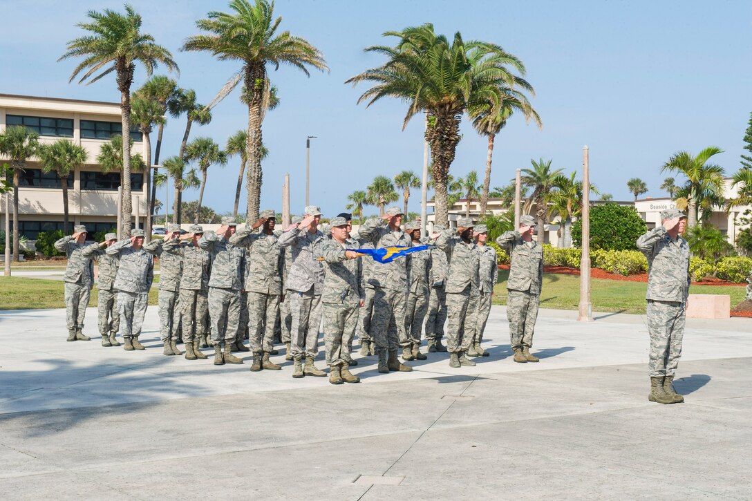 Airmen with the 45th Space Wing salute the flag during retreat April 5, 2017, at Patrick Air Force Base, Fla. The wing holds retreat quarterly to show its respect to the Stars and Stripes. (U.S. Air Force Photo by Phil Sunkel) 