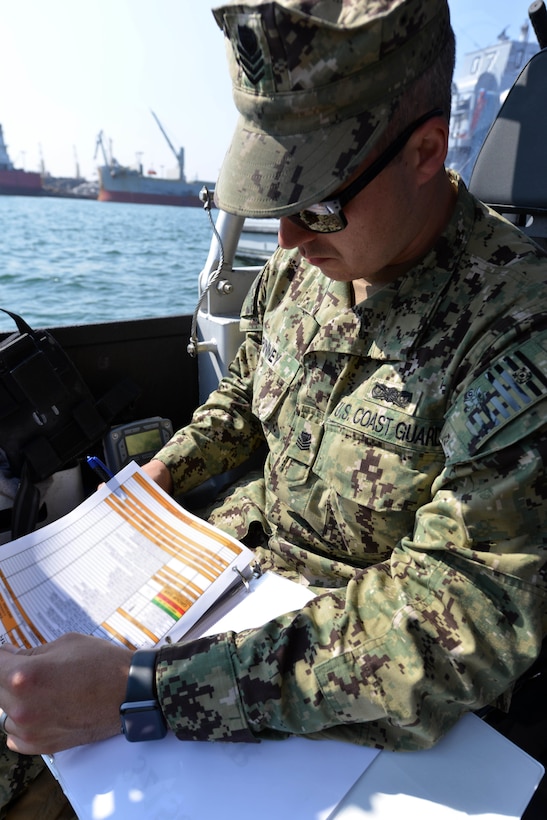 Coast Guard Petty Officer 1st Class Steven Pinney checks paperwork before getting underway during Operation Pacific Reach Exercise 2017 in Pohang, South Korea, April 3, 2017. Coast Guard photo by Lt. Dana Warr