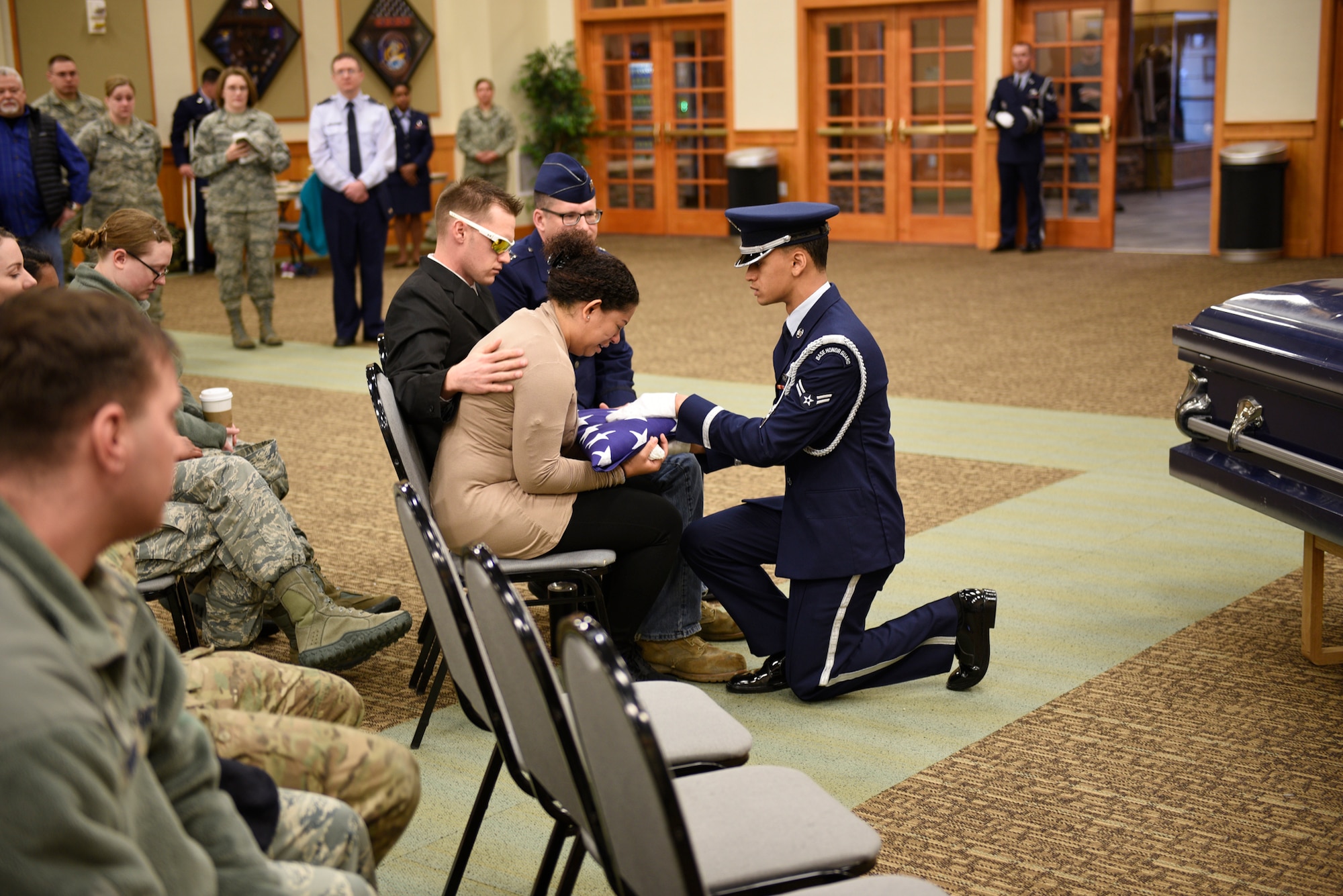 A Malmstrom Honor Guard member presents the American flag to Senior Airman Annastasia Bostic, mother of drunken driving victim, April 12, 2017, at the Grizzly Bend at Malmstrom Air Force Base, Mont. The event was part of “Live or Die,” a production helping members think about consequences before they get behind the wheel intoxicated. (U.S. Air Force photo\ Staff Sgt. Lindsey Soulsby)