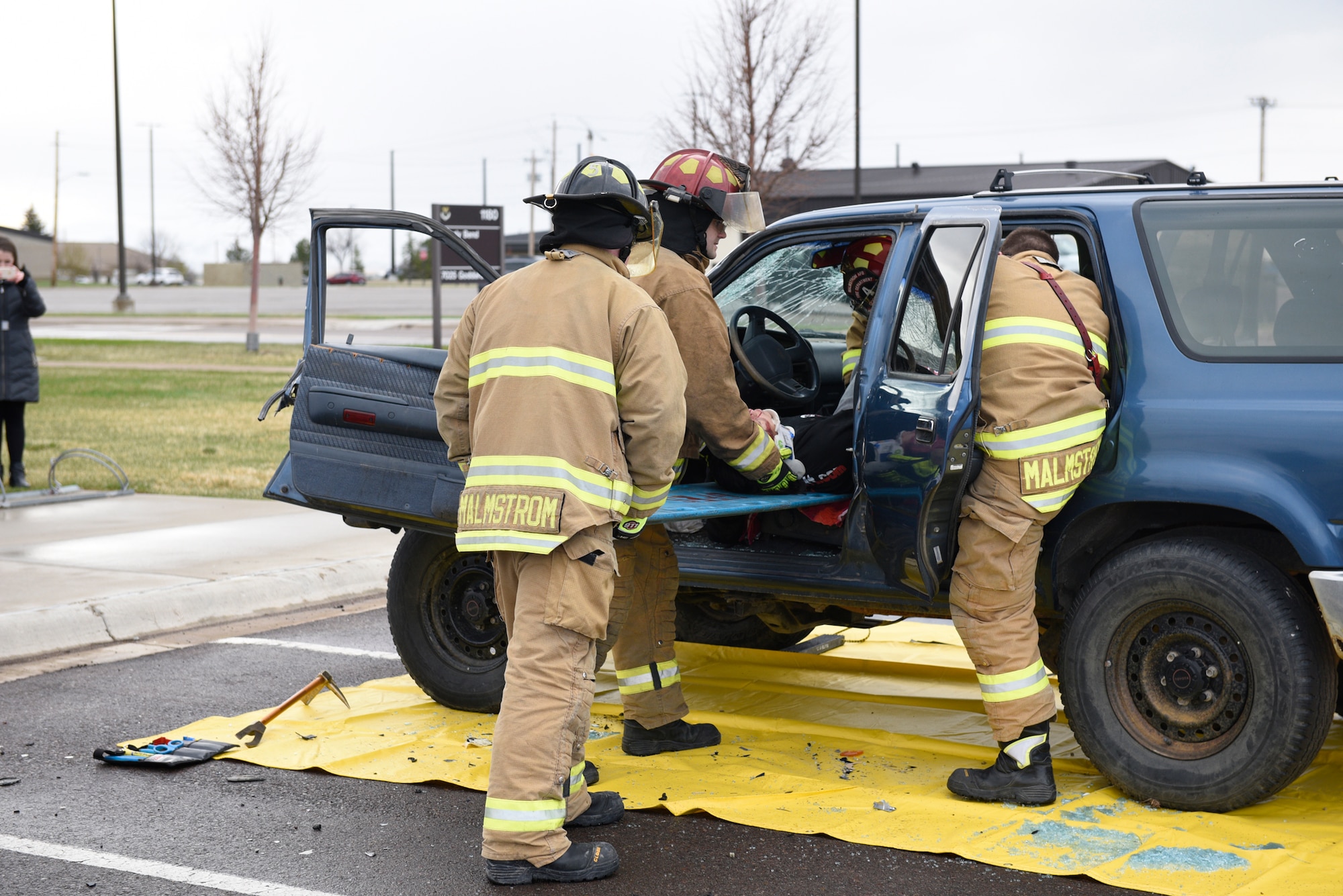 Firefighters remove an Airman acting as a drunken driving victim from a vehicle April 12, 2017, at the Grizzly Bend at Malmstrom Air Force Base, Mont. The event was part of “Live or Die,” a production helping members think about consequences before they get behind the wheel intoxicated. (U.S. Air Force photo\ Staff Sgt. Lindsey Soulsby)