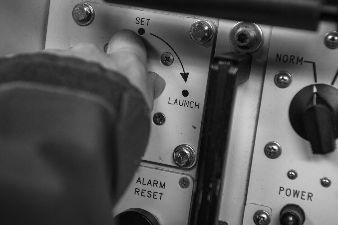 First Lt. Paul Lee, the 321st Missile Squadron missile combat crew commander, performs a simulated key turn of the Minuteman III weapon system during a Simulated Electronic Launch-Minuteman test inside the launch control center at a missile alert facility in the 90th Missile Wing's missile complex, Neb., April 11, 2017. During a SELM, the missileers in the LCC are responsible for sending commands to the Minuteman III ICBMs in the launch facility. (U.S. Air Force photo/Staff Sgt. Christopher Ruano)