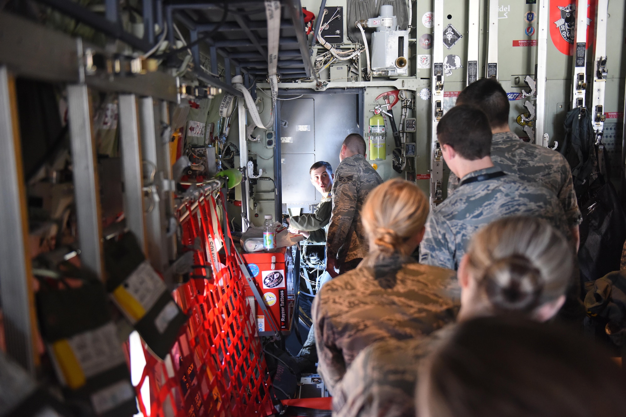 Senior Airman Ryan Dunkle, a loadmaster at the 193rd Special Operations Wing, Middletown, Pennsylvania, demonstrates and explains safety procedures to Airmen participating in the incentive flight prior to the departure of the EC-130J aircraft, April 9, 2017. According to incentive flight program regulations, guard members can be nominated by their supervisors to participate in an upcoming incentive flight.