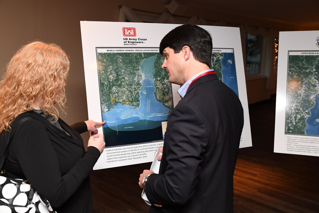 Justin McDonald speaks with a Mobile community member during the Mobile Harbor General Reevaluation Report Open House, March 16. The event was brief members of the public on the ongoing engineering, economic and environmental studies that will determine the costs, benefits and environmental impacts of improving Mobile Harbor.