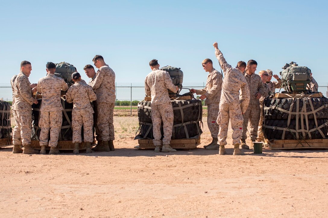 U.S. Marines prepare Joint Precision Airdrop Systems for flight during Weapons and Tactics Instructors Course 2-17 on Marine Corps Air Station, Yuma, Ariz., March 30, 2017. The JPADS uses GPS, a modular autonomous guidance unit, a parachute and electric motors to guide cargo to their targeted drop zones. The Marines were with Landing Support Company, Transportation Support Battalion, Combat Logistics Regiment 1, 1st Marine Logistics Group and Landing Support Company, 2nd TSB, CLR- 2, 2nd MLG. (U.S. Marine Corps photo by Lance Cpl. Roderick Jacquote)