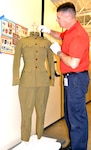 Christopher Goodrow, U.S. Army Medical Department Museum, AMEDD Center of History and Heritage museum specialist, tends to a World War I uniform worn by Capt. Douglas Venable, who served in the war. The uniform is one of 55 artifacts that will be included in a temporary exhibit opening April 28 at the AMEDD Museum at Joint Base San Antonio-Fort Sam Houston, marking the 100th anniversary of the U.S. entry into World War I and the role of the U.S. Army Medical Department in the war.