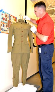 Christopher Goodrow, U.S. Army Medical Department Museum, AMEDD Center of History and Heritage museum specialist, tends to a World War I uniform worn by Capt. Douglas Venable, who served in the war. The uniform is one of 55 artifacts that will be included in a temporary exhibit opening April 28 at the AMEDD Museum at Joint Base San Antonio-Fort Sam Houston, marking the 100th anniversary of the U.S. entry into World War I and the role of the U.S. Army Medical Department in the war.