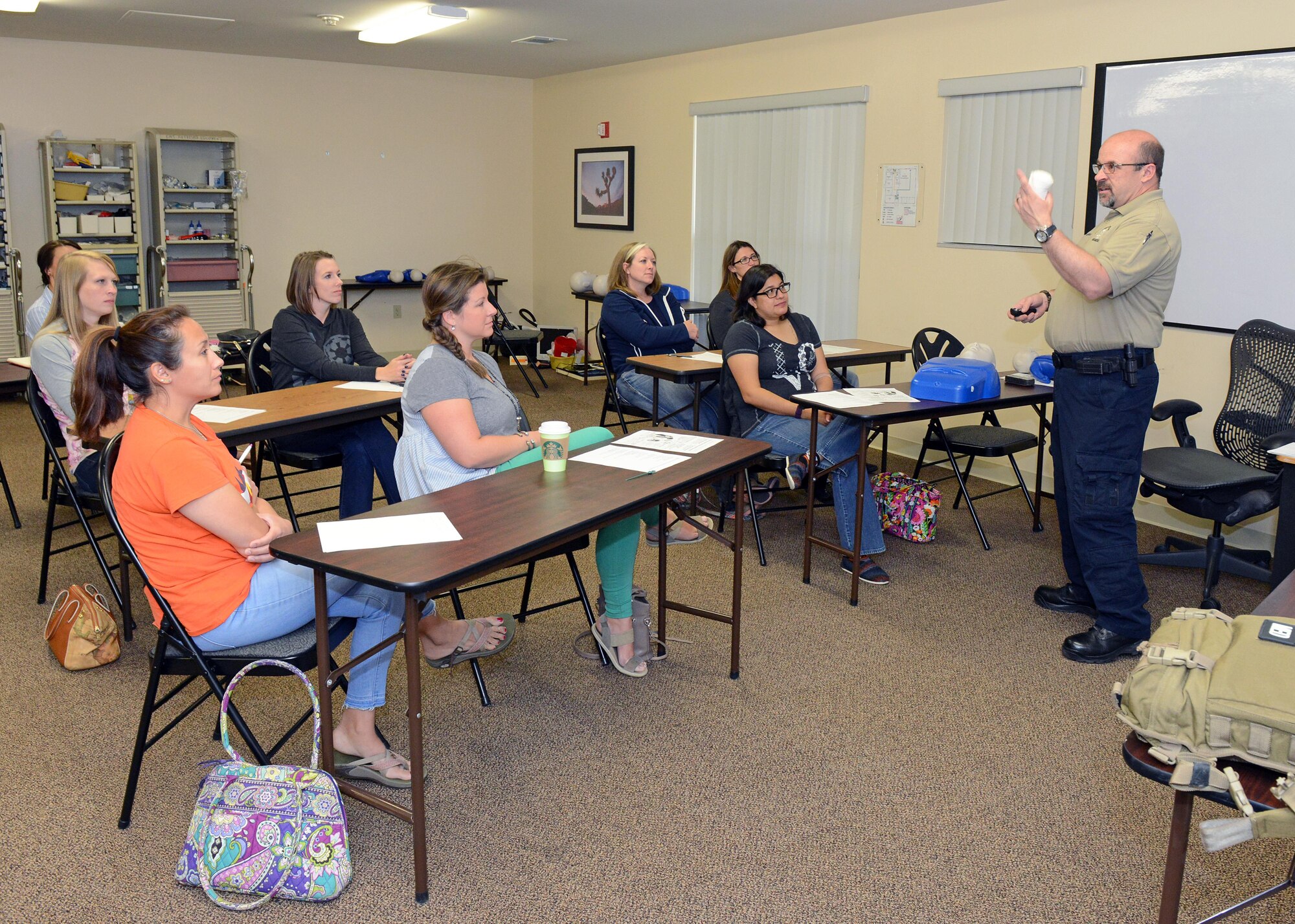 Timothy Reynolds, 412th Medical Operations Squadron medical technician, demonstrates CPR to a class attended by base spouses April 7. The 412th MDOS held three classes during the week at the 412th Medical Group Education and Training building. (U.S. Air Force photo by Kenji Thuloweit)