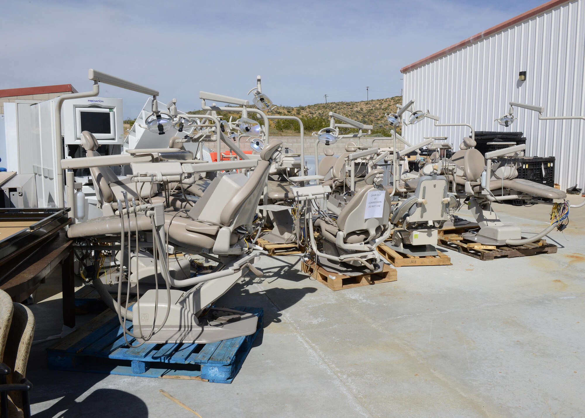 The old dental chairs sit in a lot behind the Main Clinic and will be shipped to the Defense Reutilization and Marketing Office at a later date. (U.S. Air Force photo by Kenji Thuloweit)