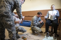 Airmen from the 49th Civil Engineer Squadron explosive ordnance disposal team performs electronic diagnostics on a hostage improvised explosive device to disarm it during training at Holloman Air Force Base, N.M. Apr. 7, 2017. The 49th CES EOD flight hosted an advanced electronics diagnostic course with EOD Airmen from Misawa Air Force Base, Japan and Cannon Air Force Base N.M. This training taught EOD Airmen about today's up and coming electronics technology and how these technologies can be incorporated by bomb makers.  During the course, students learned advanced electronic circuitry and how to analyze and interpret how it functions the IED in order to safely disarm a bomb. (U.S. Air Force photo by Staff Sgt. Stacy Jonsgaard)