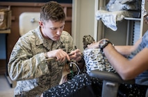 Senior Airman Derrick White, 27th Civil Engineer Squadron explosive ordnance disposal technician performs electronic diagnostics on a hostage improvised explosive device to disarm it during training at Holloman Air Force Base, N.M. Apr. 7, 2017. The 49th Civil Engineer Squadron EOD flight hosted an advanced electronics diagnostic course with EOD Airmen from Misawa Air Force Base, Japan and Cannon Air Force Base, N.M. This training taught EOD Airmen about today's up and coming electronics technology and how these technologies can be incorporated by bomb makers.  During the course, students learned advanced electronic circuitry and how to analyze and interpret how it functions the IED in order to safely disarm a bomb. (U.S. Air Force photo by Staff Sgt. Stacy Jonsgaard)