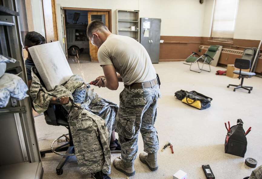 Senior Airman Benjamin Vetter 49th Civil Engineer Squadron explosive ordnance disposal technician attempts to gain access to an improvised explosive device in order to disarm it during training at Holloman Air Force Base N.M. Apr. 7, 2017. The 49th CES EOD flight hosted an advanced electronics diagnostic course with EOD Airmen from Misawa Air Force Base, Japan and Cannon Air Force Base N.M. This training taught EOD Airmen about today's up and coming electronics technology and how these technologies can be incorporated by bomb makers.  During the course, students learned advanced electronic circuitry and how to analyze and interpret how it functions the IED in order to safely disarm a bomb. (U.S. Air Force photo by Staff Sgt. Stacy Jonsgaard)