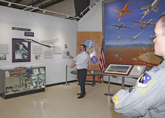 Dr. Chris Cotting, U.S. Air Force Test Pilot School master instructor of flying qualities, tosses a glider for a class demonstration at the Air Force Flight Test Museum April 4. (U.S. Air Force photo by Stephen K. Robinson)