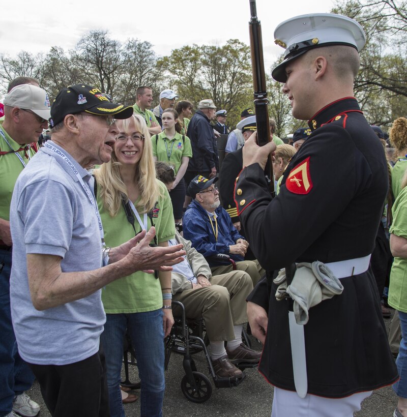 Members of the Marine Corps Silent Drill Platoon meet and greet with veterans of Honor Flight Chicago after their performance at the Marine Corps War Memorial, Arlington, Va., Apr. 12, 2017. Each year, veterans of World War II and the Korean War visit Washington, D.C. for a day of honor and remembrance at no cost. (Official Marine Corps photo by Cpl. Robert Knapp/Released)