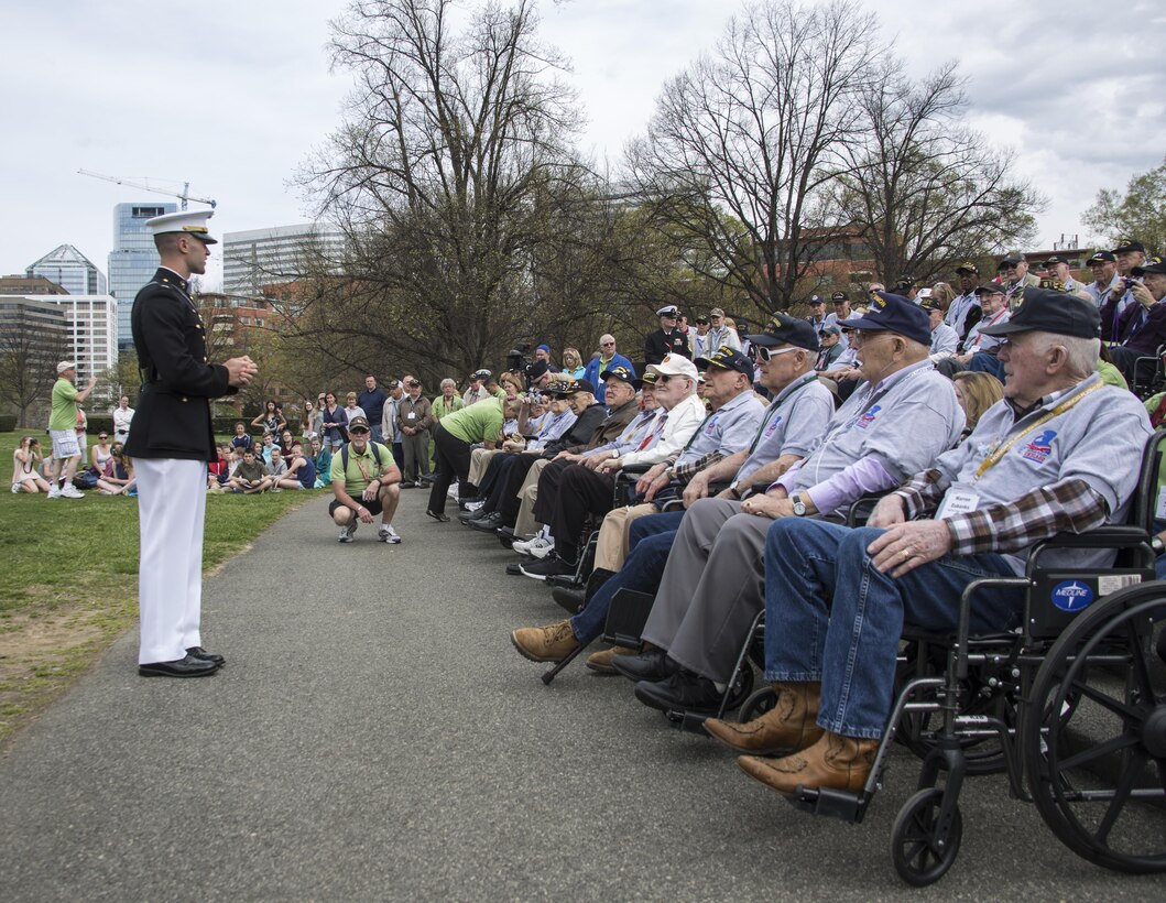 Captain Gregory Jurshak, platoon commander, Marine Corps Silent Drill Platoon, speaks to veterans with Honor Flight Chicago at the Marine Corps War Memorial, Arlington, Va., Apr. 12, 2017. Each year, veterans of World War II and the Korean War visit Washington, D.C. for a day of honor and remembrance at no cost. (Official Marine Corps photo by Cpl. Robert Knapp/Released)
