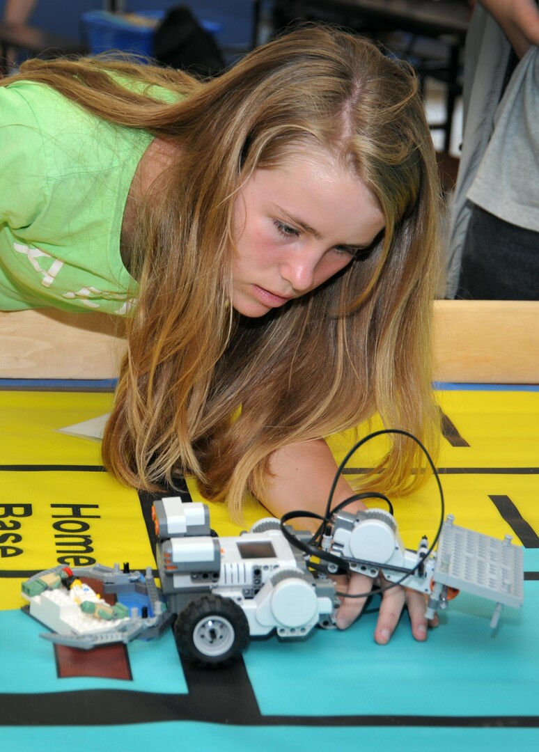 A middle school student uses remote-controlled models to solve simulated naval robotic missions at a science, technology, engineering and mathematics summer academy, sponsored by the National Defense Education Program. The annual summer academy ran from June 24 to 28 at the Naval Surface Warfare Center in Dahlgren, Va. Ninety-five students from five school districts engaged in the summer camp. 
