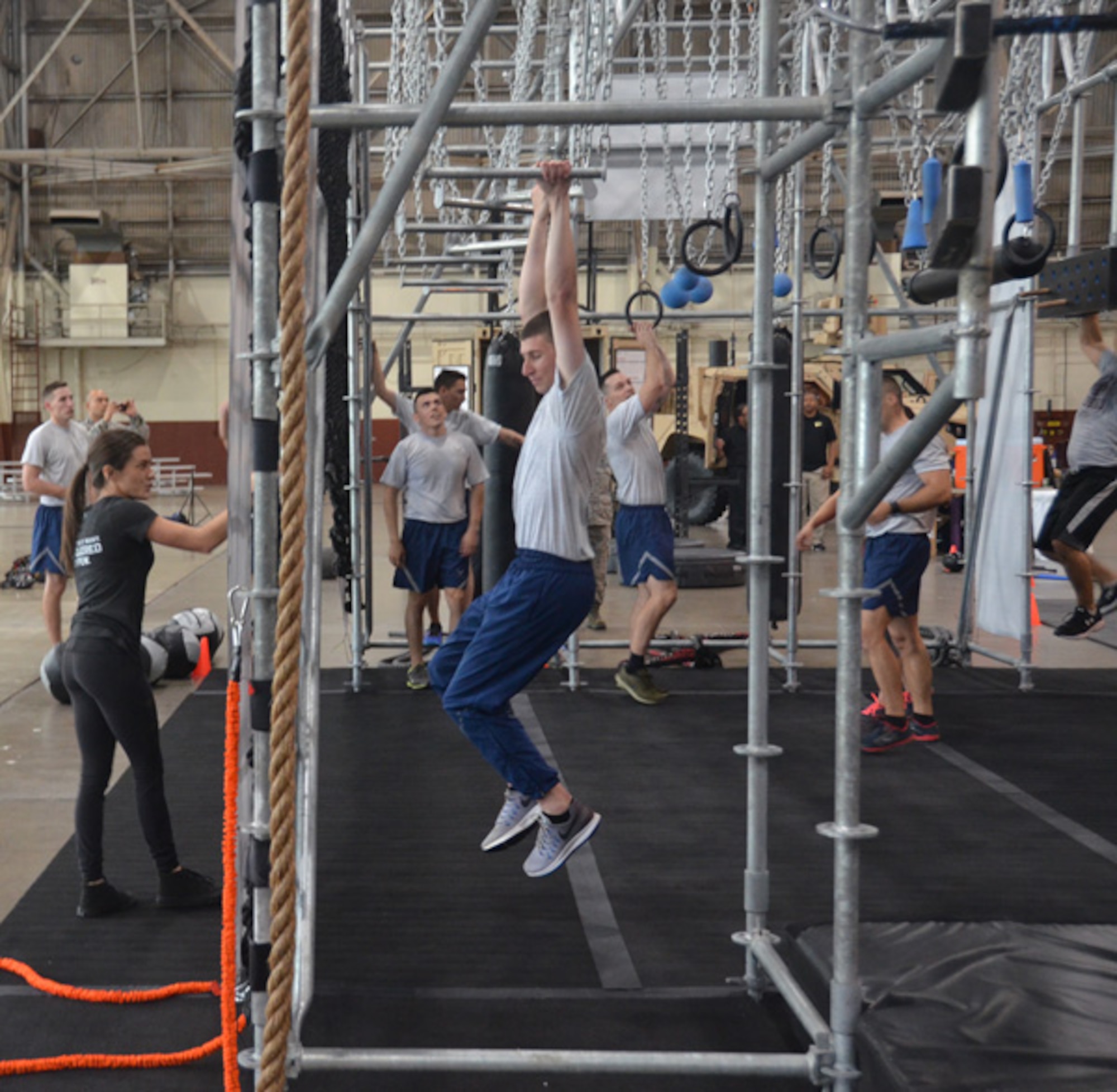 Senior Airman Jonathan Rutledge of the 502nd Communication Squadron at JBSA-Lackland, Texas, navigates the swinging bars portion of the Battle Rig April 11. (U.S. Air Force photo/Steve Warns)