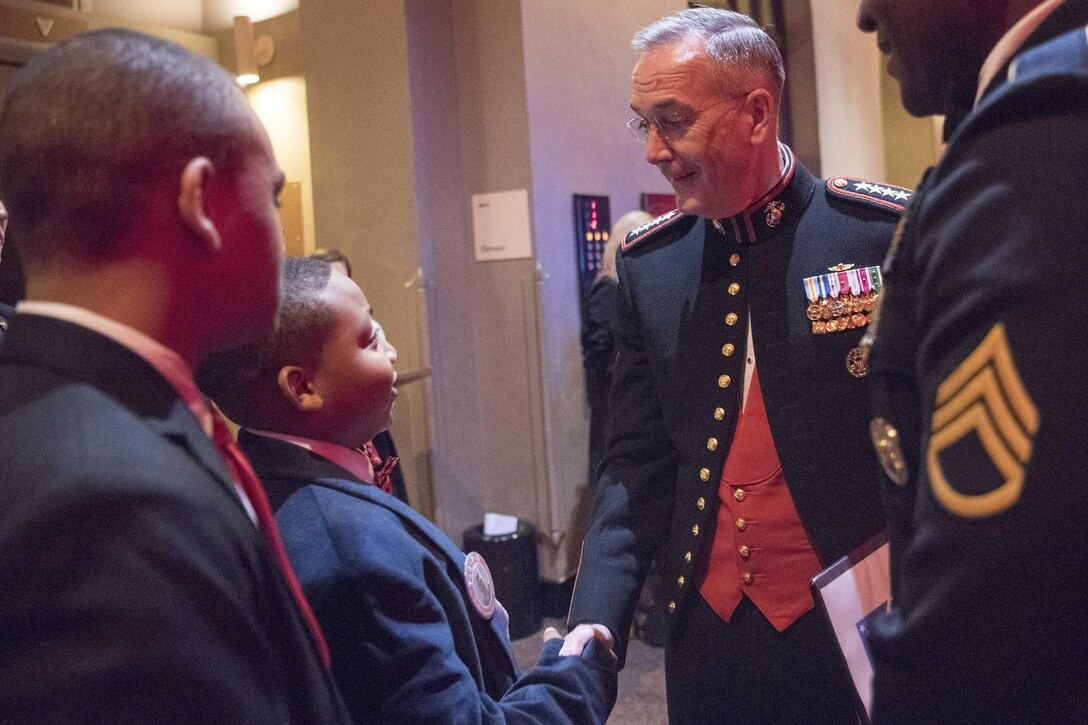 Marine Corps Gen. Joe Dunford, chairman of the Joint Chiefs of Staff, exchanges greetings with youth attending the Tragedy Assistance Program for Survivors 2017 Honor Guard Gala in Washington, D.C., April 12, 2017. Dunford served as the event’s keynote speaker. DoD photo by Navy Petty Officer 2nd Class Dominique A. Pineiro