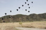 Low cost aerial delivery systems, each loaded with four, 55-gallon drums of water, reach the ground after being dropped from a Republic of Korea Air Force C-130, April 12, 2017, into a drop zone between Daegu and Busan, South Korea. ExOPR17 focuses on integrating Republic of Korea and U.S. Alliance logistics capabilities within air, land, maritime, space and information environments.