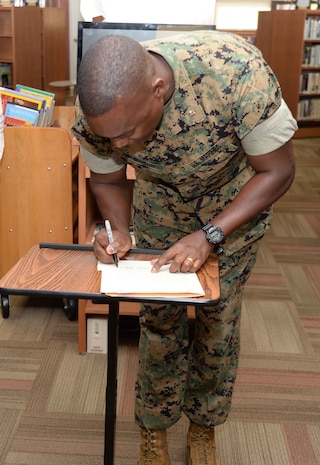 Library supporters and patrons celebrate the Grand Re-Opening of the newly-renovated Base Library and National Library Week at Marine Corps Logistics Base Albany, April 12. Lt. Col. Nathaniel Robinson, executive officer, MCLB Albany, read and signed the proclamation at the event.
