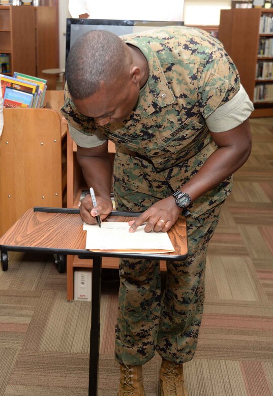 Library supporters and patrons celebrate the Grand Re-Opening of the newly-renovated Base Library and National Library Week at Marine Corps Logistics Base Albany, April 12. Lt. Col. Nathaniel Robinson, executive officer, MCLB Albany, read and signed the proclamation at the event.
