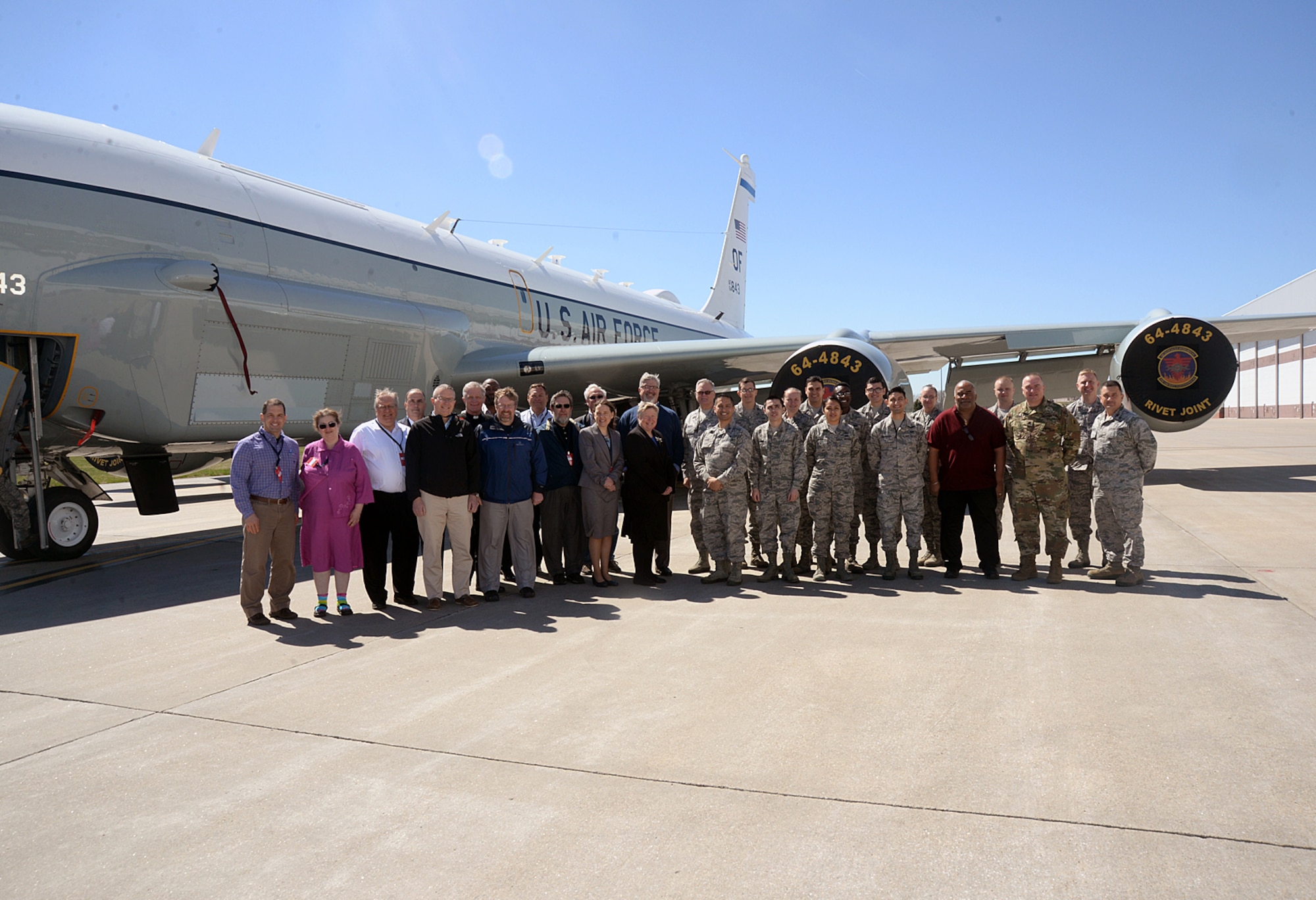 A group of more than 20 ministry leaders from across the Omaha metro area pose for a group photo outside of an RC-135V/W Rivet Joint during the 2017 Clergy Partnership Event here on April 6. The Offutt Chapel hosted the event with a goal of engaging local clergy from various faith groups and traditions in order to provide for the spiritual care of the base’s military members and their families. (U.S. Air Force photo by Kendra Williams)