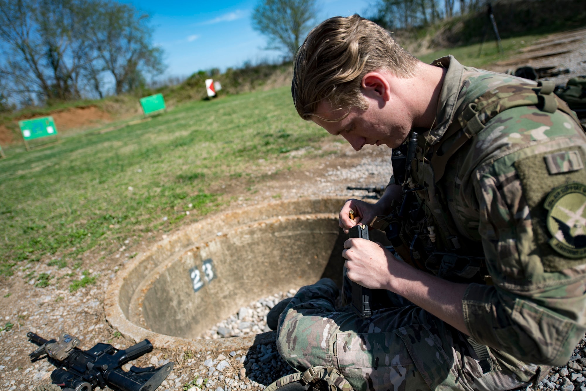 U.S. Air Force Senior Airman Brandon Malinowski, 19th Air Support Operations Squadron Tactical Air Control Party specialist loads ammo before attempting a German armed forces proficiency badge assessment, April 4, 2017, at Fort Campbell, Ky. To enhance their ability to work together in deployed locations, members of the German Air Force travelled to Fort Campbell to train and exercise with the 19th ASOS. While at Fort Campbell, The German Air Force members hosted a German armed forces proficiency assessment for Airmen consisting of shooting firearms, swimming, agility exercises and a rucksack march.