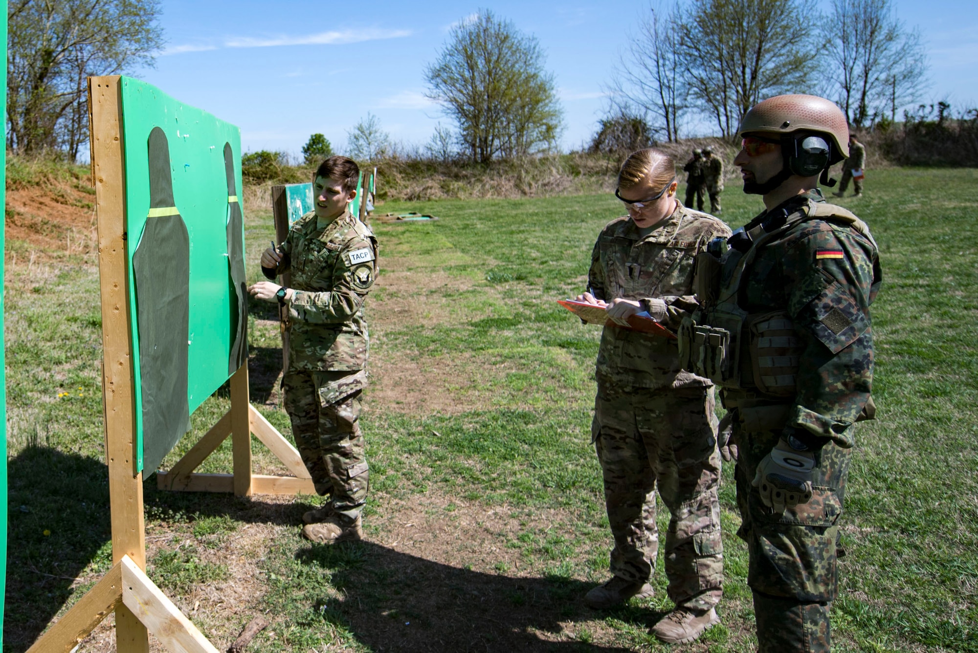 U.S. Air Force Staff Sgt. Christopher Torrez, left, 19th Air Support Operations Squadron Tactical Air Control Party specialist, counts the number of shots on target while 1st Lt. Megan Cox, 19th ASOS air liaison officer, and German Air Force Maj. Nader Samadi, German Air Ground Operations Squadron commander observe during the shooting portion of the a German armed forces proficiency assessment, April 4, 2017, at Fort Campbell, Ky. While at Fort Campbell, The German Air Force members hosted a German armed forces proficiency assessment for Airmen consisting of shooting firearms, swimming, agility exercises and a rucksack march.