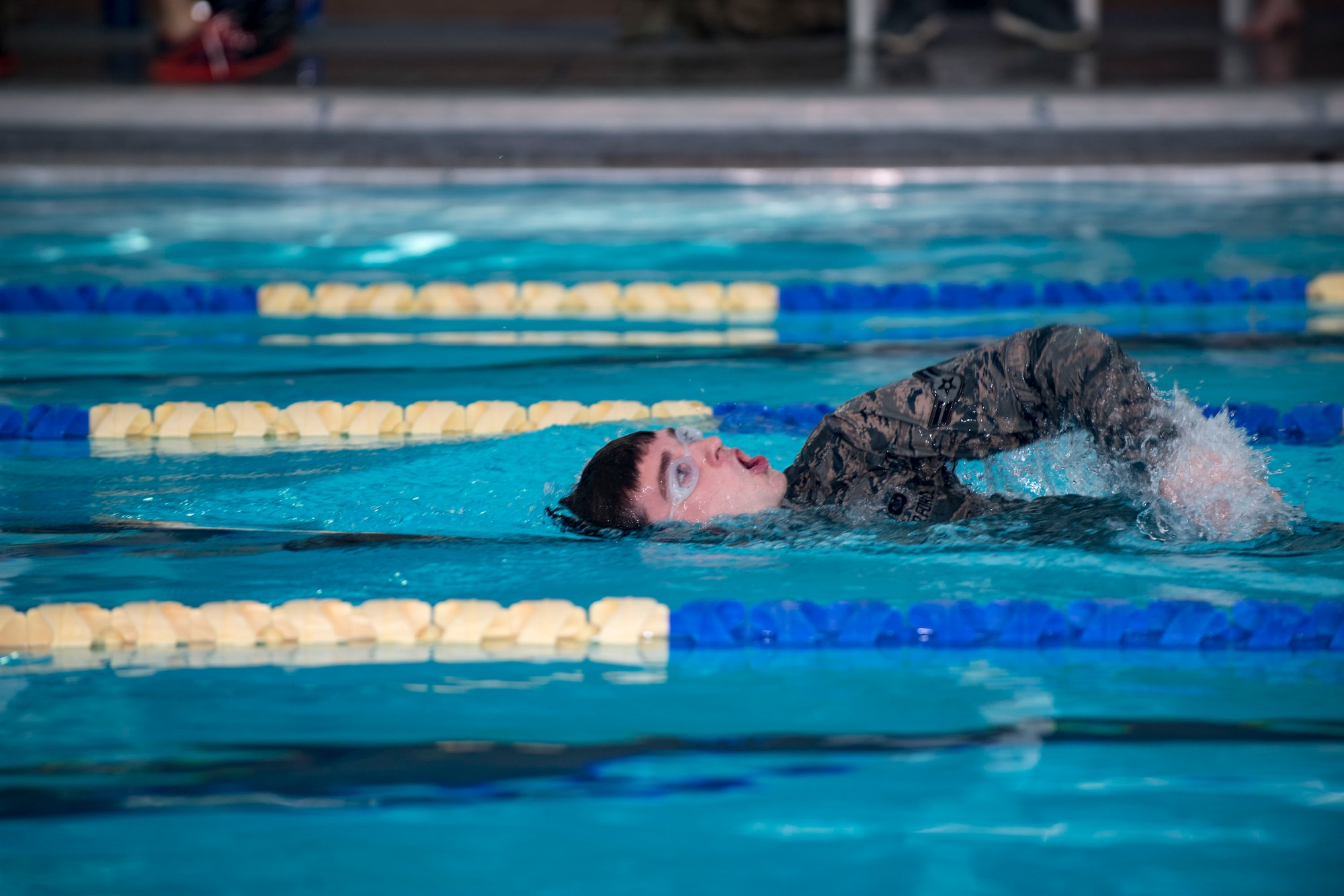 U.S. Air Force Airman 1st Class Aaron Gadd, 19th Air Support Operations Squadron Tactical Air Control Party specialist swims during a German armed forces proficiency assessment, April 5, 2017, at Fort Campbell, Ky. To enhance their ability to work together in deployed locations, members of the German Air Force travelled to Fort Campbell to train and exercise with the 19th ASOS. While at Fort Campbell, The German Air Force members hosted a German armed forces proficiency assessment for Airmen consisting of shooting firearms, swimming, agility exercises and a rucksack march.