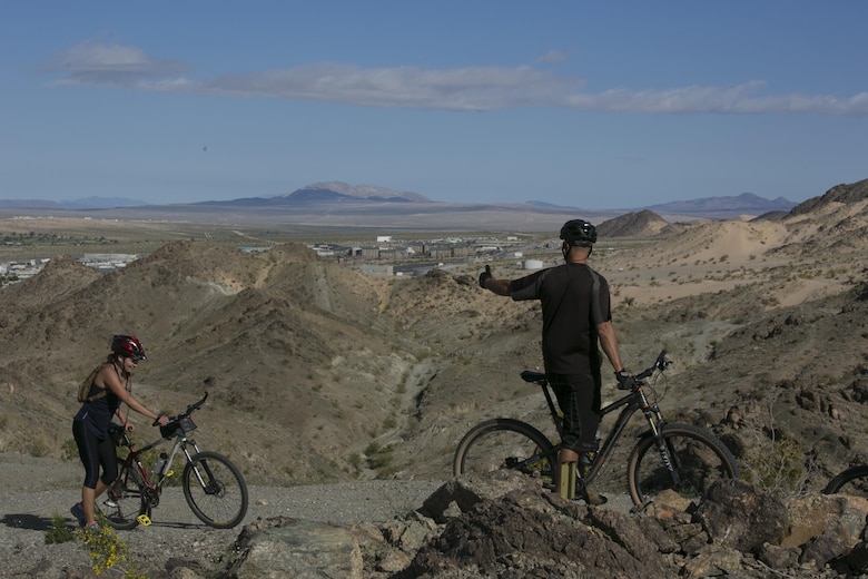 A participant motives a fellow cyclist the annual Earth Day Bike ride held aboard Marine Corps Air Ground Combat Center, Twentynine Palms, Calif., April 8, 2017. The 11-mile ride started at Range. (U.S. Marine Corps photo by Lance Cpl. Dave Flores)