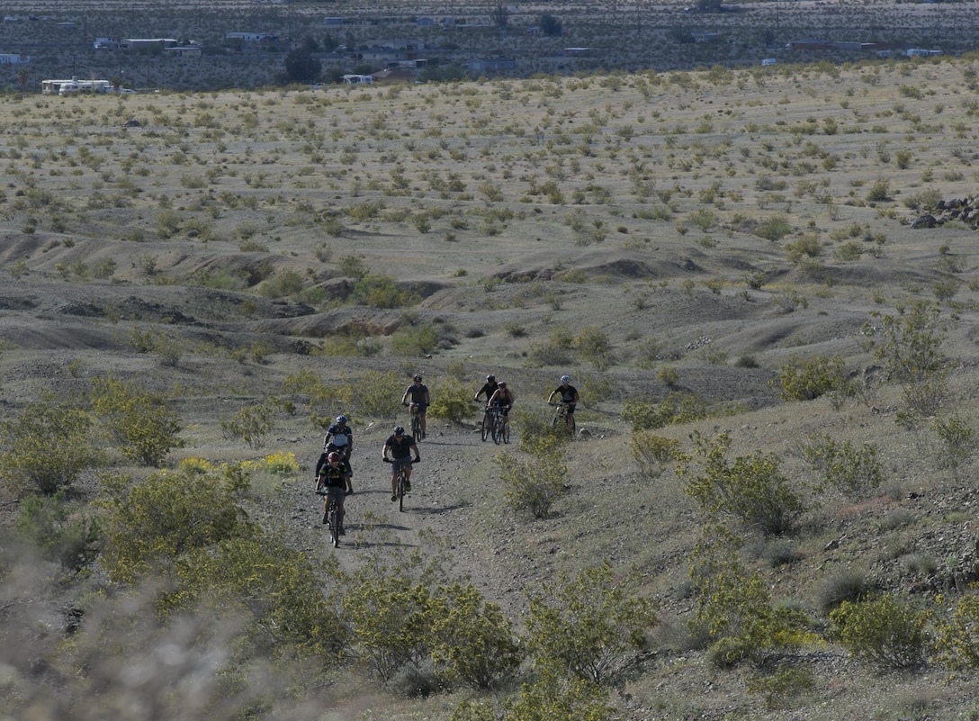 Participants navigate the Combat Center Bike Trail during the annual Earth Day Bike ride held aboard Marine Corps Air Ground Combat Center, Twentynine Palms, Calif., April 8, 2017. The 11-mile ride started at Range 100. (U.S. Marine Corps photo by Lance Cpl. Dave Flores)