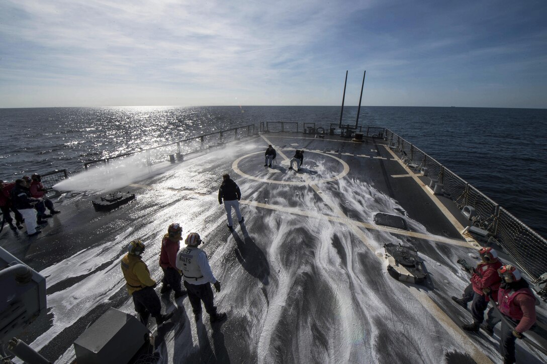 Sailors test flight deck sprinklers during a helicopter crash and salvage drill aboard USS Carney in the Atlantic Ocean, April 11, 2017. The guided-missile destroyer is patrolling in the U.S. 6th Fleet area of operations to support U.S. national security interests in Europe. Navy photo by Petty Officer 3rd Class Weston Jones