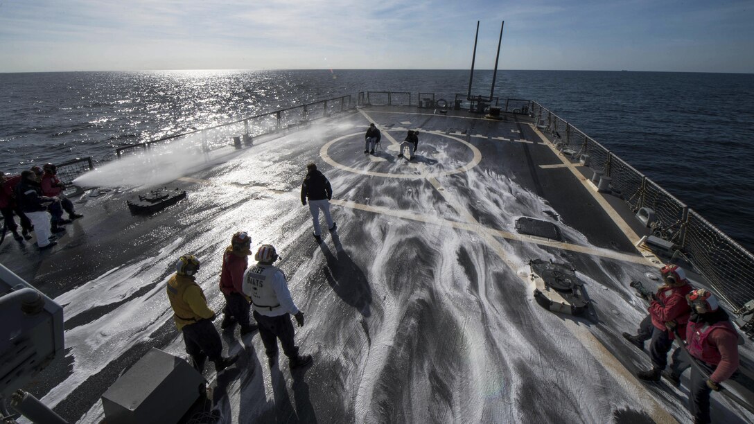 Sailors test flight deck sprinklers during a helicopter crash and salvage drill aboard USS Carney in the Atlantic Ocean, April 11, 2017. The guided-missile destroyer is patrolling in the U.S. 6th Fleet area of operations to support U.S. national security interests in Europe. Navy photo by Petty Officer 3rd Class Weston Jones