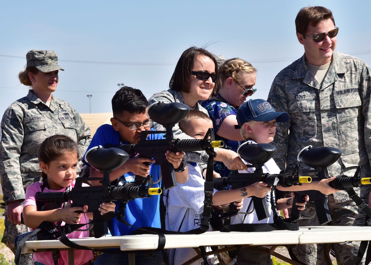 Airmen watch over children of members from the 944th Fighter Wing as they fire paint balls Apr. 1 during Operation Reserve Kids at Luke Air Force Base, Ariz. (U.S. Air Force photo by Tech. Sgt. Louis Vega Jr.)