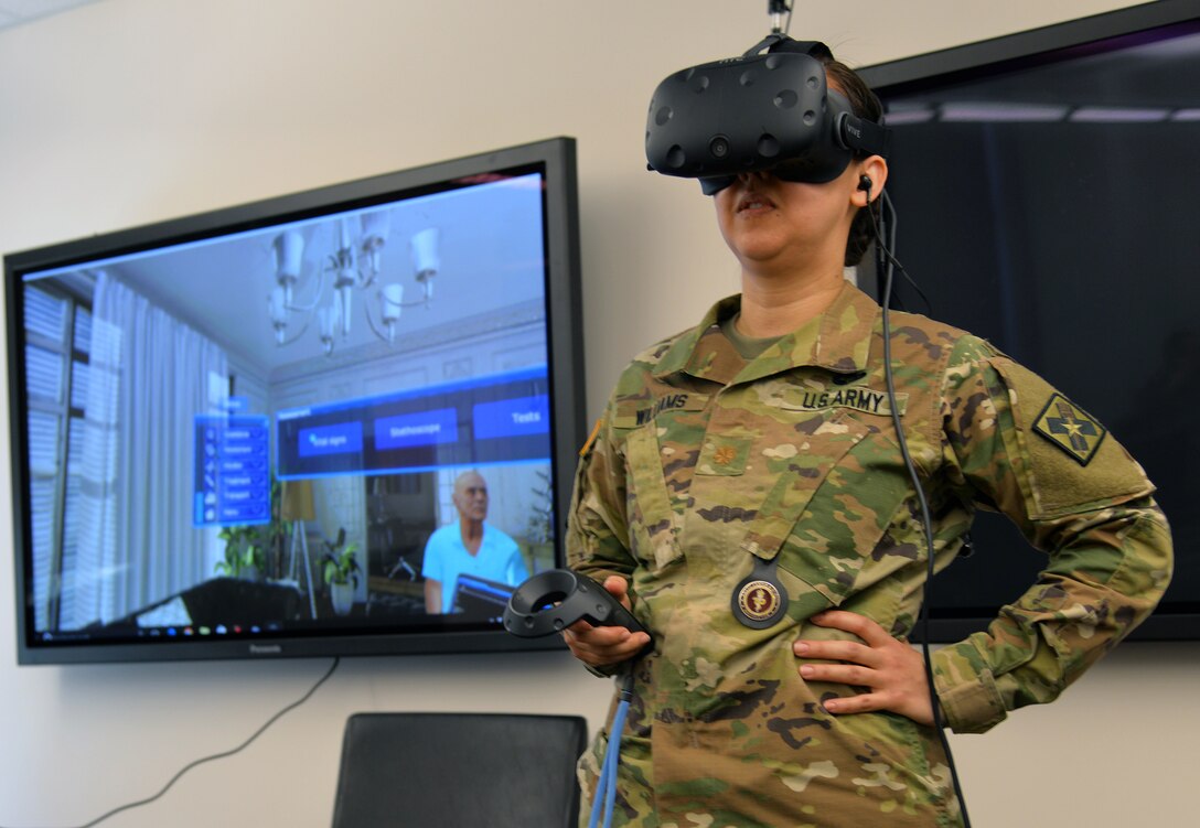 Maj. Jean Williams, Medical Education Training Campus Department of Combat Medic Training branch chief, participates in a demonstration of the Virtual Education System at Heritage Hall at Joint Base San Antonio-Fort Sam Houston April 1. VES is a virtual reality based training platform in which the learner interacts with a virtual patient in various situations, including at a home, an ambulance and a hospital room.