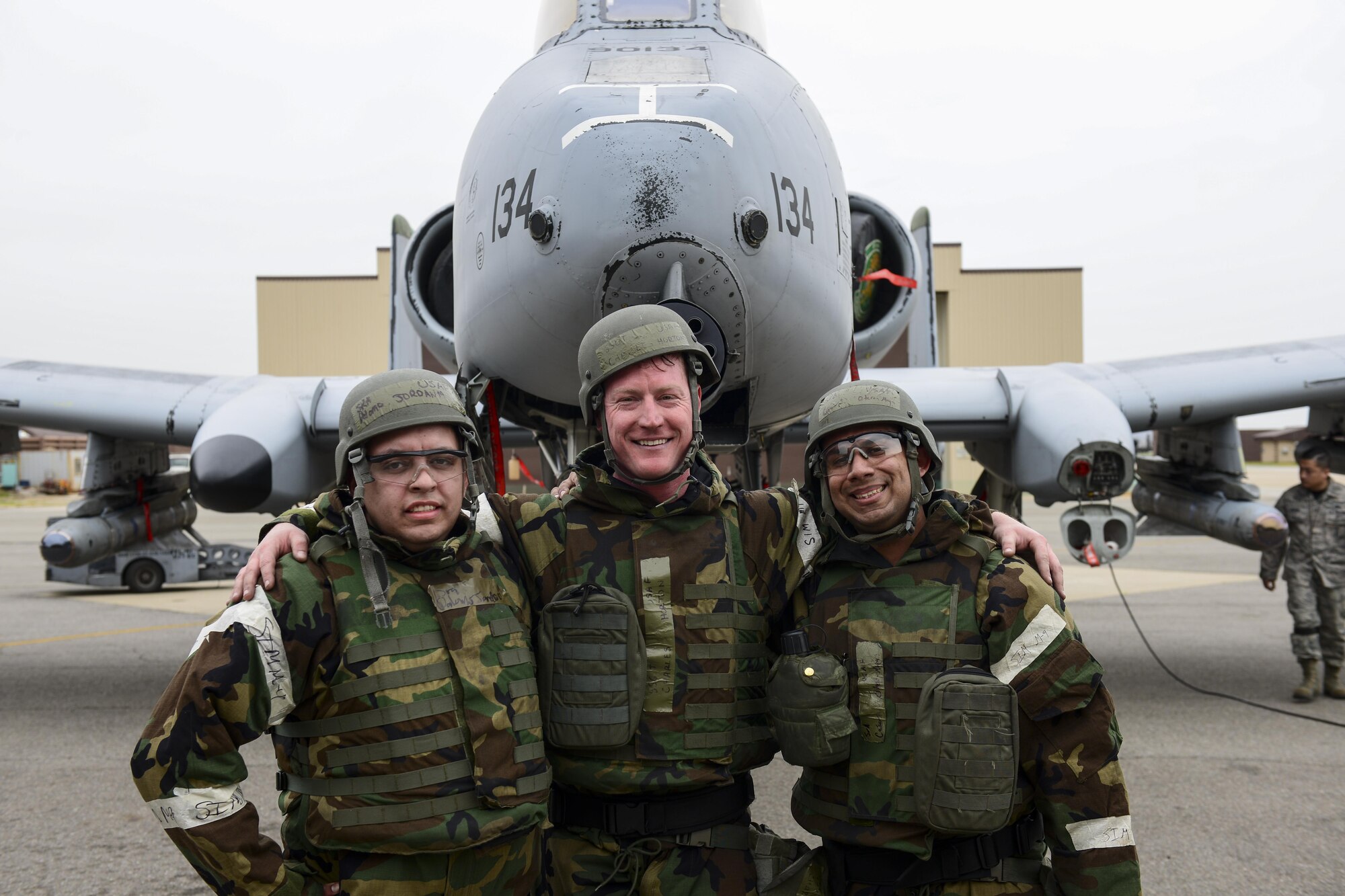 U.S. Air Force Senior Airmen Jordan Palomo and Cesar Otero-Moya pose with U.S. Air Force Staff Sgt. Charles Horton in front of an A-10 Thunderbolt II after participating in the 51st Maintenance Group’s quarterly weapons load crew competition at Osan Air Base, Republic of Korea, April 14, 2017. The three Airmen represented the 25th Aircraft Maintenance Unit against the 36th AMU and the New Jersey Air National Guard’s 177th Aircraft Maintenance Squadron in the competition. (U.S. Air Force photo by Staff Sgt. Victor J. Caputo)