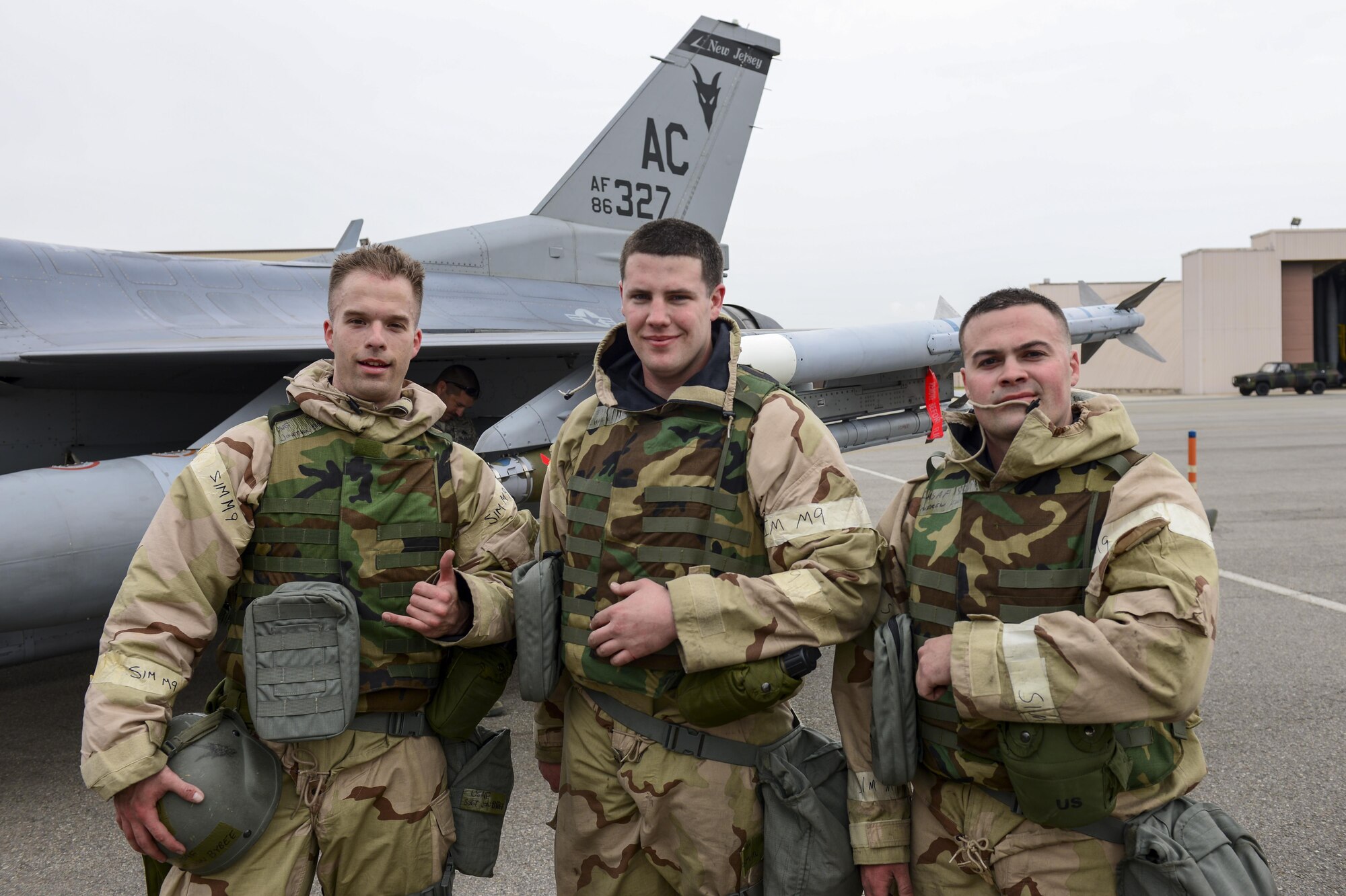 U.S. Air Force Staff Sgt. Jon Bybee and U.S. Air Force Senior Airmen Charles Michel and Andrew Finnegan, 177th Aircraft Maintenance Squadron weapons load crew members, pose in front of an F-16 Fighting Falcon at Osan Air Base, Republic of Korea, April 14, 2017. The Airmen are deployed to Osan from the New Jersey Air National Guard’s 177th Fighter Wing, competed against their active duty counterparts in the 51st Maintenance Group’s quarterly weapons load crew competition. (U.S. Air Force photo by Staff Sgt. Victor J. Caputo)